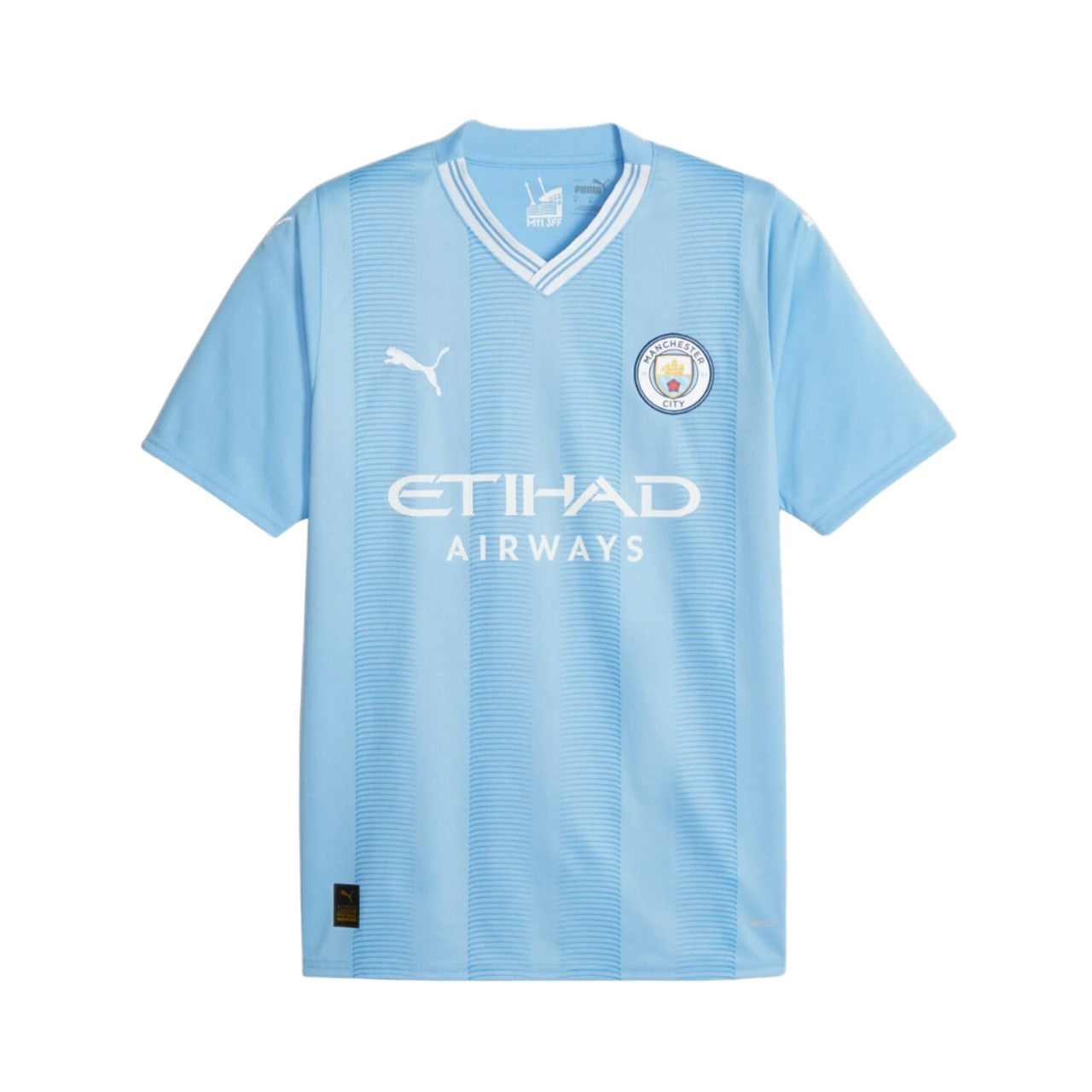 Camiseta Manchester City local 2023/2024 vista sobre fondo blanco